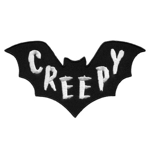 "CREEPY" script in white embroidered on black bat-shaped iron or sew on patch