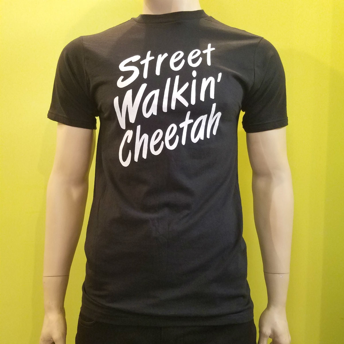 "Street Walkin' Cheetah" fitted black unisex/men's sizing t-shirt shown on mannequin