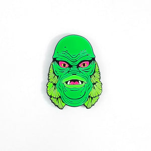 Enamel pin in neon green colors of the Creature from the Black Lagoon
