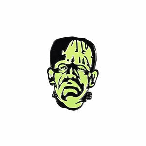 Glow-in-the-dark green enameled black metal pin depicting Boris Karloff in his iconic role as the monster from the classic 1931 movie, Frankenstein