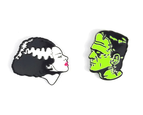 Glow-in-the-dark enamel pin set depicting the iconic "We Belong Dead" profile poses of Boris Karloff as the monster and Elsa Lanchester as his mate from the classic 1935 movie, Bride of Frankenstein
