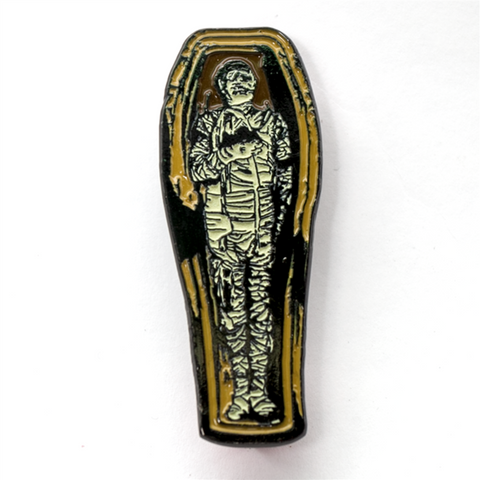 1" x 2.5" Universal Studios horror character the Mummy at rest in his coffin glow-in-the-dark enamel pin 