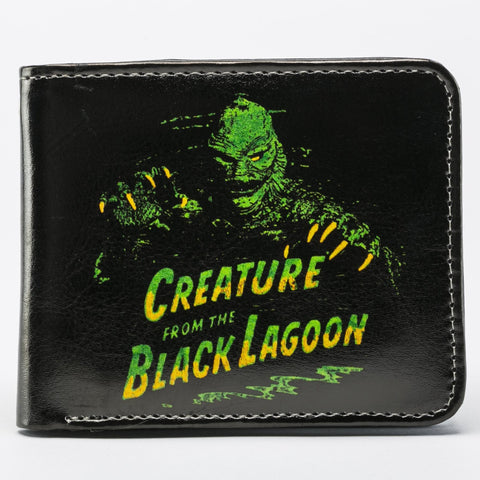 Black faux leather billfold wallet with a printed green & yellow image on front of the Creature from The Black Lagoon swimming toward you behind the logo from the classic 1954 movie