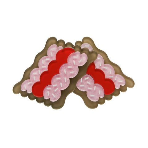 two "Vovos" pink frosting, red jam, and white sprinkles topped biscuits layered resin brooch