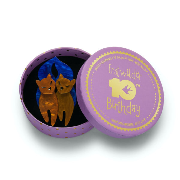 pair of golden brown kitties with blue tails layered resin brooch, shown in illustrated round box packaging