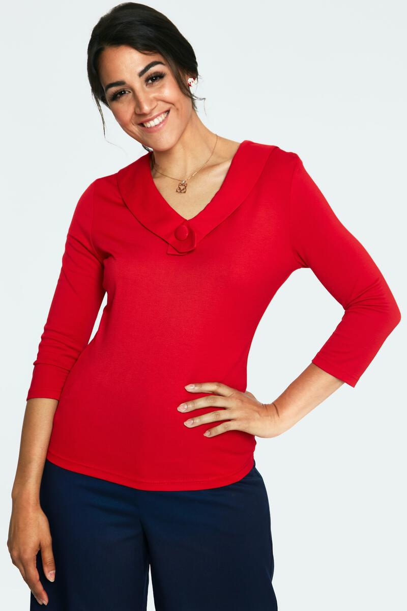 bright red stretch knit top with collared v-neckline with covered button detail, 3/4 length sleeves, fitted silhouette, and hip length. shown on model.