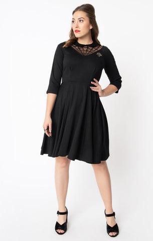 black stretch knit fit & flare silhouette, 3/4 sleeves, Peter Pan collar, front and back v-shaped spiderweb mesh neckline design dress removable spider brooch, shown on model