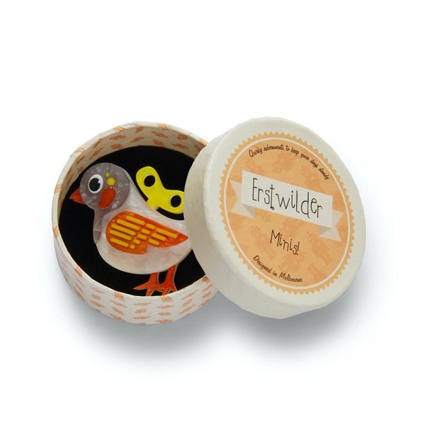 white, grey, orange, and yellow layered resin 2" key-operated toy bird brooch, shown in illustrated Erstwilder round giftbox