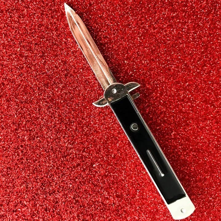 shiny silver metal and black enamel switchblade stiletto knife lapel pin with retractable blade