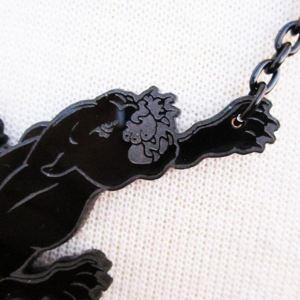 3 1/2" laser-cut and etched opaque black acrylic panther pendant on 18" black metal link chain, shown close up