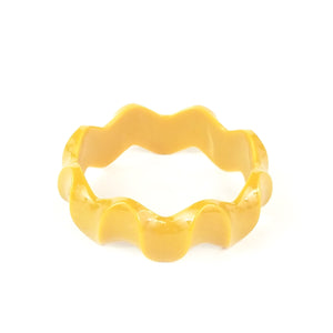 1" wide shiny plastic wavy rickrack shape bangle in mustard yellow