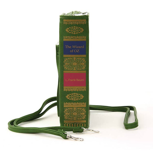 Side view of the purse. It has gold, blue, and pink printed decoration meant to be in the style of an old hardcover book. It lists the title “The Wizard of Oz” and the author as “L. Frank Baum”.