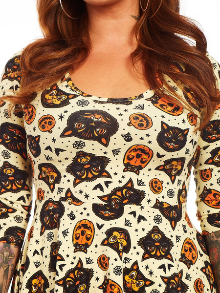 "Classic Halloween" print 3/4 sleeve scoop neck skater dress in cream background allover orange, black, and white cats, bats, jack-o'-lanterns, and spiderwebs print on a stretch cotton knit fabric, shown on model