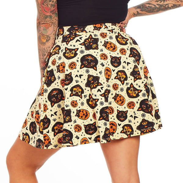 stretchy cotton knit "Classic Halloween" print cream background allover orange, black, and white cats, bats, jack-o'-lanterns, and spiderwebs print skater skirt, shown back view on model