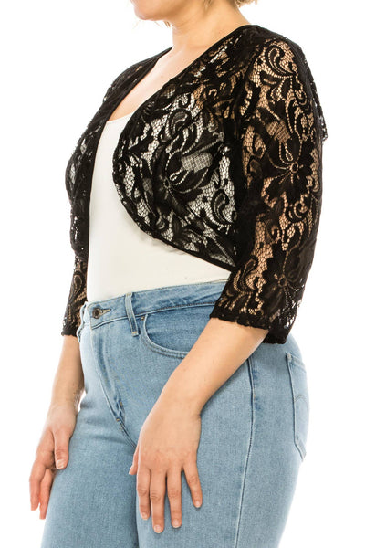 black floral patterned lace 3/4 sleeve bolero with solid black trim worn by a model shown from the side