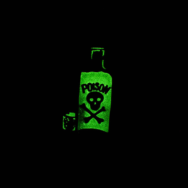 Glow-in-the-dark toxic green skull & crossbones labeled poison bottle shaped enameled black metal pin, shown glowing in the dark