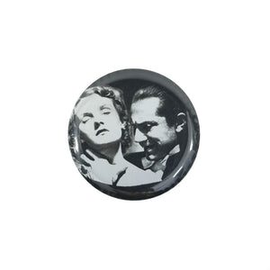 This 1.5" round metal Bela Lugosi as "Dracula" button features a black and white image of Dracula about to bite a woman's neck
