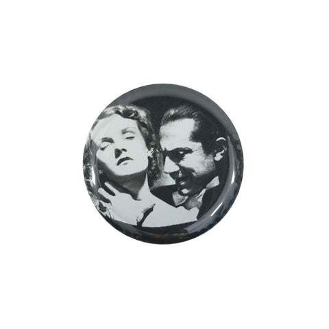 This 1.5" round metal Bela Lugosi as "Dracula" magnet features a black and white image of Dracula about to bite a woman's neck