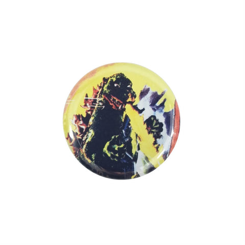 This 1.5" round Godzilla button features a color image of Godzilla breathing fire against a yellow background