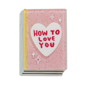 "How to Love You" title in white heart sparkly pink book layered resin brooch