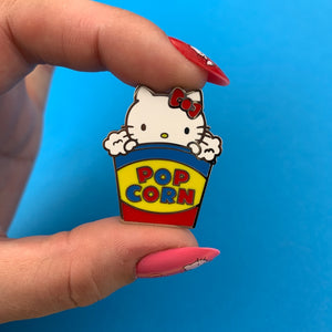 Hello Kitty Collection "Popcorn" white cat head red bow in red yellow blue popcorn container enameled silver metal clutch back pin