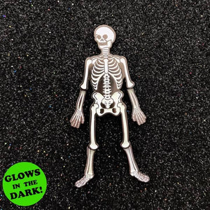 shiny gunmetal and glow-in-the-dark white enamel skeleton lapel pin with moving elbow and knee joints