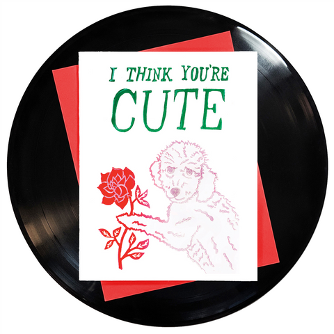4.25" x 5.5" card I Think You're Cute green text over blush pink goldendoodle dog holding red rose, stamped image against white background