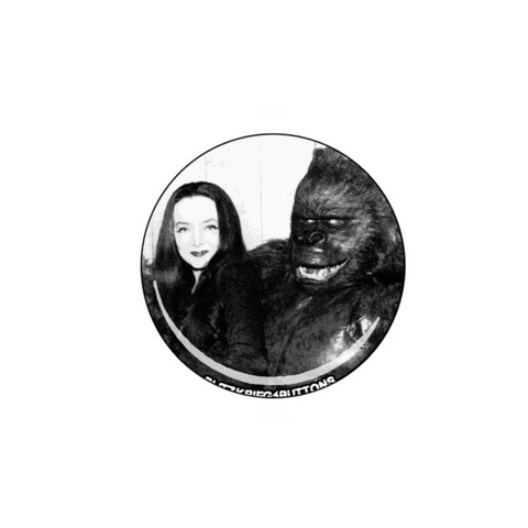 black and white photo image of Carolyn Jones in character as 60s tv mom Morticia Addams shown with gorilla on 1.25" round metal pinback button