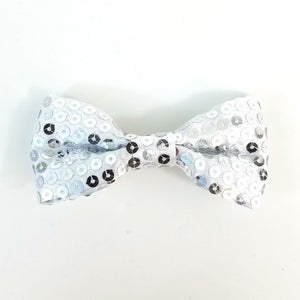 4" x 2" bow hair clip of in silvery grey satin with shiny matching color sewn-on sequins and 2 1/8" gator clip fastener