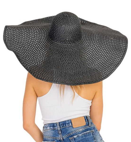 9.5" wide broad wired brim openwork woven paper over black net floppy black sun hat, shown back view on model