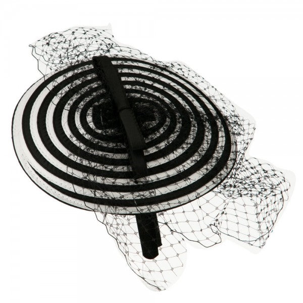 black and white spiral swirl fascinator with black bow and netting on a satin covered headband