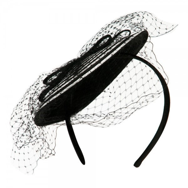 black and white spiral swirl fascinator with black bow and netting on a satin covered headband