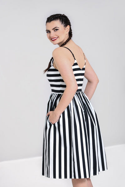Juno 50s Dress black & white stripe print sweetheart neckline, fitted princess seamed bodice with adjustable black spaghetti straps and gathered just-below-the-knee length skirt, shown back 3/4 view on model