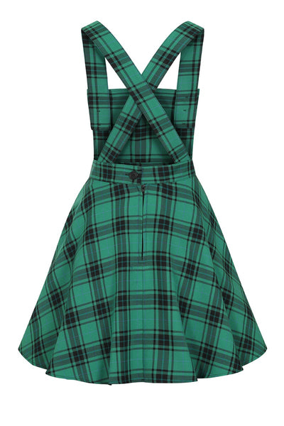 green and black plaid pinafore dress with crossover straps, front button closure, nipped in waist, and flared above the knee length skirt
