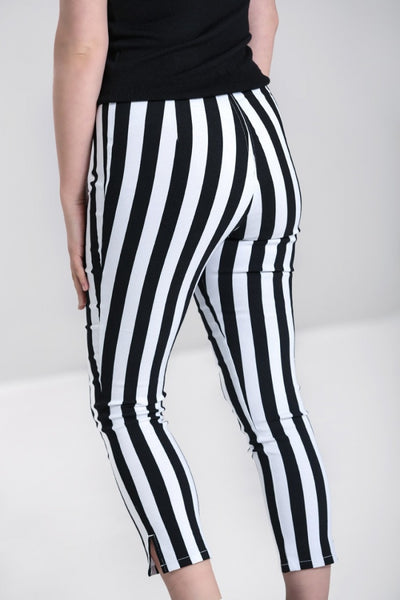 retro high waist fitted stretch capri length pants in vertical black & white stripe print, shown back view on model