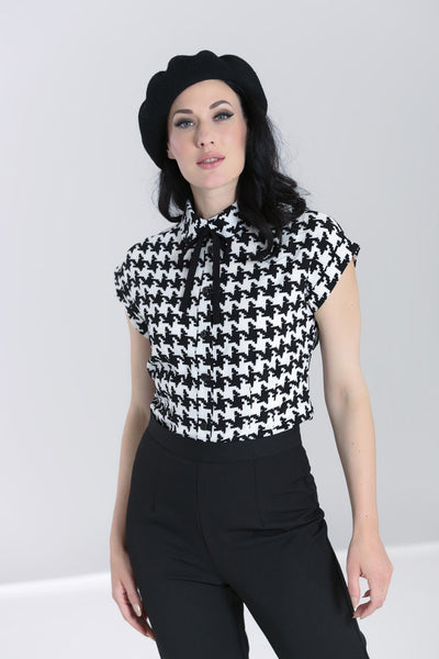 black and ivory houndstooth print short sleeve blose with black fabric tie at collar, shown on model
