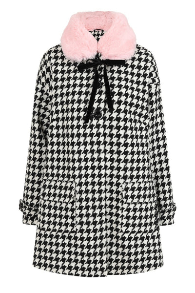 Black & white houndstooth long sleeve a-line coat with removable pink faux fur collar finished with a black velvet ribbon tie, shiny black buttons, and big patch pockets