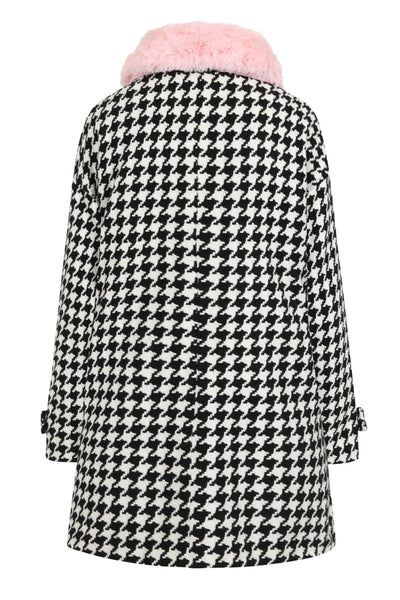 Black & white houndstooth long sleeve a-line coat with removable pink faux fur collar finished with a black velvet ribbon tie, shiny black buttons, and big patch pockets, shown back view