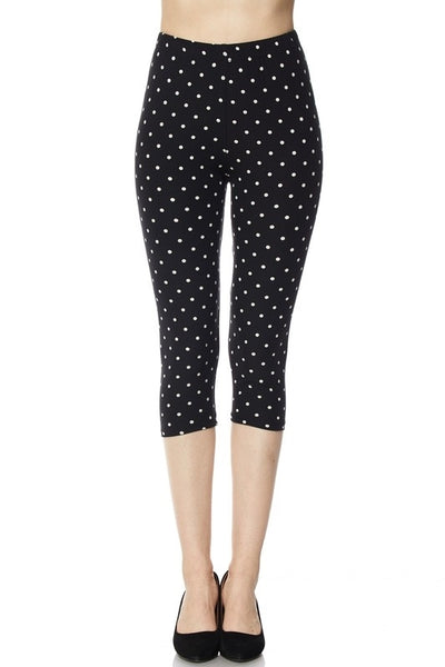 high-waist capri length leggings in a black & white polka dot print, shown on model