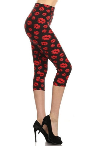 high-waist capri length leggings in black with an allover (S.W.A.K.!) red lipstick kiss print, shown waist down on model, side view