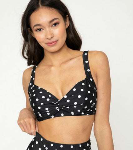 retro style back & white polka dot swim top twist-front detail, sweetheart neckline, removable light padding, and adjustable wide set straps. shown on model