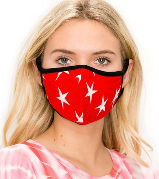red with white star print knit face mask with black trim and ear loops, shown on model