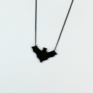 black faux leather 1 7/8" x 1 1/8" bat pendant on 17" - 18.5" delicate black metal link chain with lobster claw clasp
