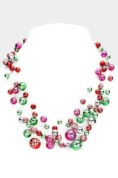 multi-strand necklace of metallic solid and decorated clear lucite beads that look just like vintage holiday ornaments, strung on clear filament