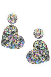 A pair of heart-shaped acrylic drop earrings filled with iridescent starburst-shaped pieces of glitter. 