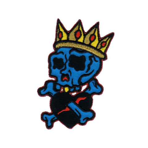 blue skull wearing gold crown, with crossed bones piercing a black heart embroidered patch