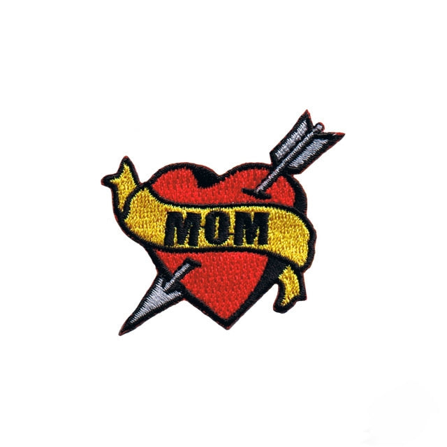 tattoo flash arrow-pierced red heart patch with black stitched "MOM" on yellow banner embroidered patch
