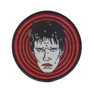 3" round embroidered patch of Lux Interior's glamour ghoul face against hot red & black concentric circle background