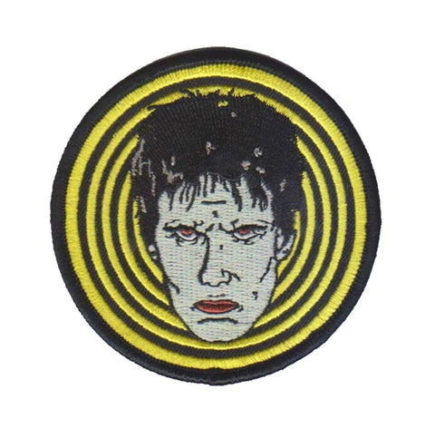 3" round embroidered patch of Lux Interior's glamour ghoul face against hot yellow & black concentric circle background