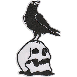 black raven standing on white skull embroidered patch
